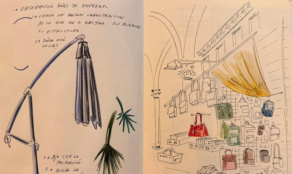 An open notebook showing two pencil sketches, one of a lamp and the other of designer handbags