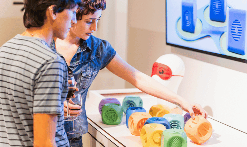 Two people in front of a design exhibition project