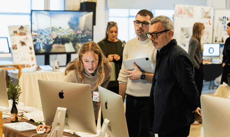 Three people looking at a computer screen