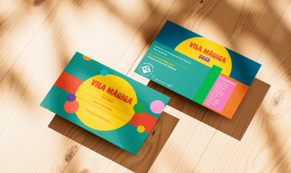 Two cards with a color-block design on a light wood floor